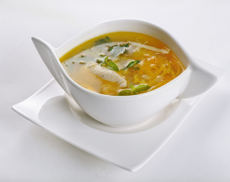 An isolated shot of a white bowl with hot and sour soup - perfect for a food blog or menu usage